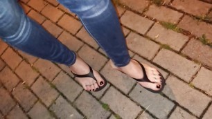 a crossdresser with beautiful feet walks the street and seduces in sexy flip-flops