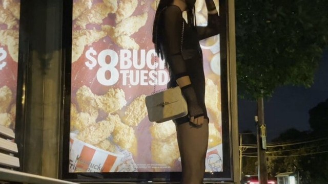 Crossdresser waiting for bus in short dress at night