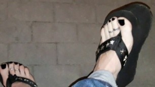 a crossdresser on a night walk walks around and tempts with his beautiful feet