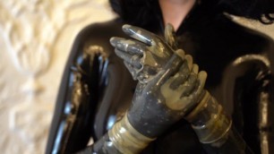 Trying on Transparent Latex Gloves on a Catsuit